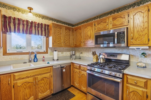 kitchen featuring sink, stainless steel appliances, and light hardwood / wood-style flooring