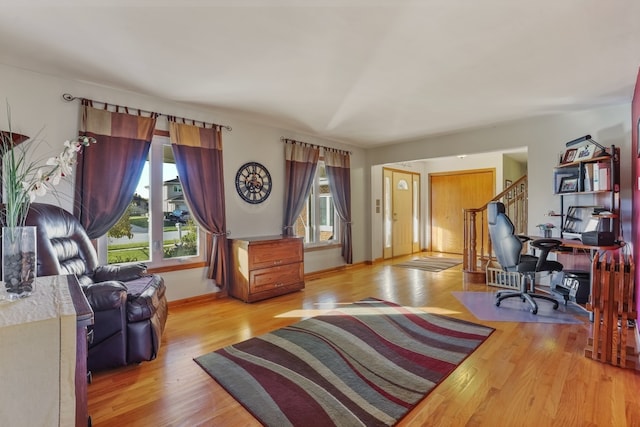 home office with light hardwood / wood-style flooring