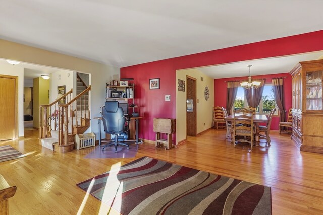 living room featuring hardwood / wood-style floors and an inviting chandelier