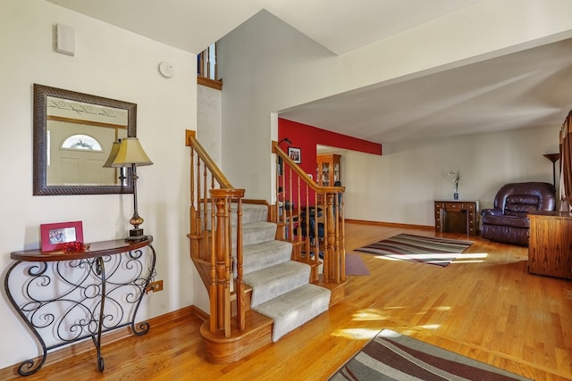 staircase with hardwood / wood-style flooring