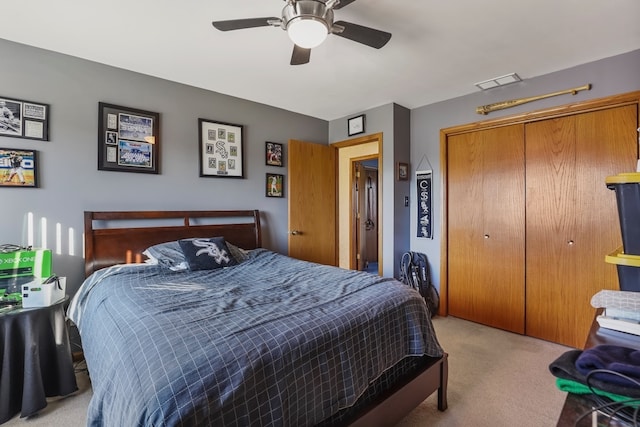 carpeted bedroom with a closet and ceiling fan