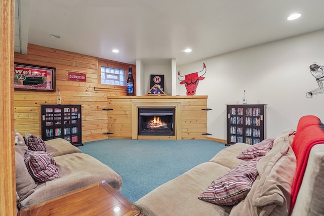 carpeted living room with wood walls