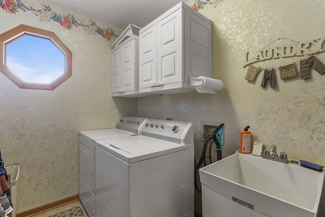 laundry room with washer and clothes dryer, sink, and cabinets