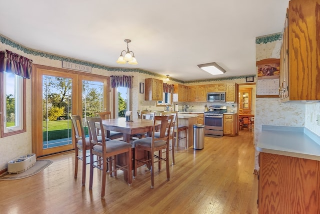 dining room featuring light hardwood / wood-style flooring and an inviting chandelier