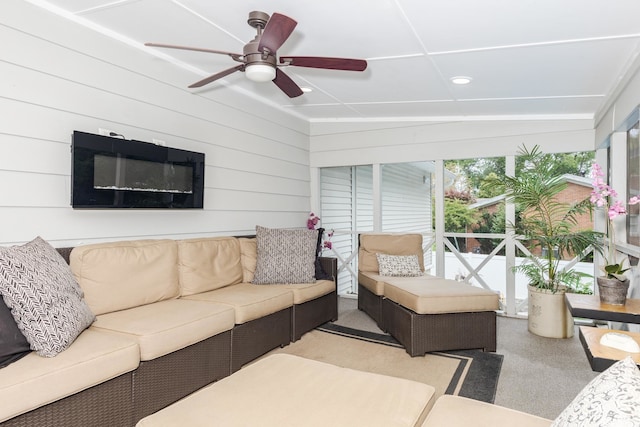 carpeted living room featuring ceiling fan