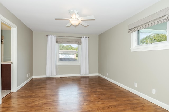 unfurnished room with a wealth of natural light, ceiling fan, and hardwood / wood-style floors