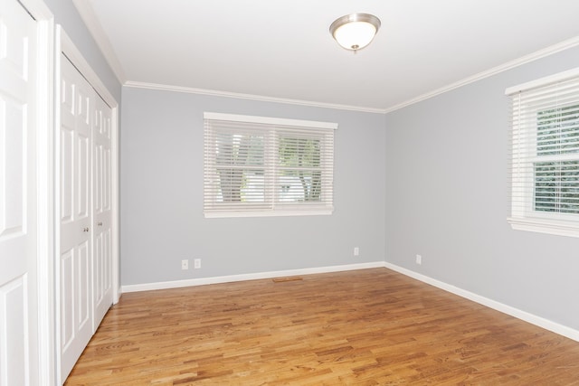 unfurnished bedroom featuring light hardwood / wood-style floors and crown molding