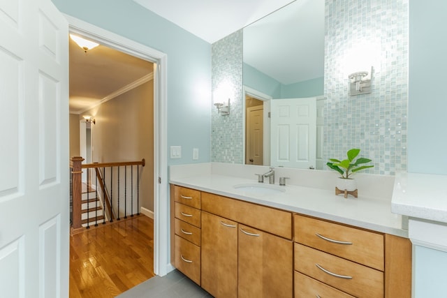 bathroom with vanity, hardwood / wood-style flooring, and ornamental molding