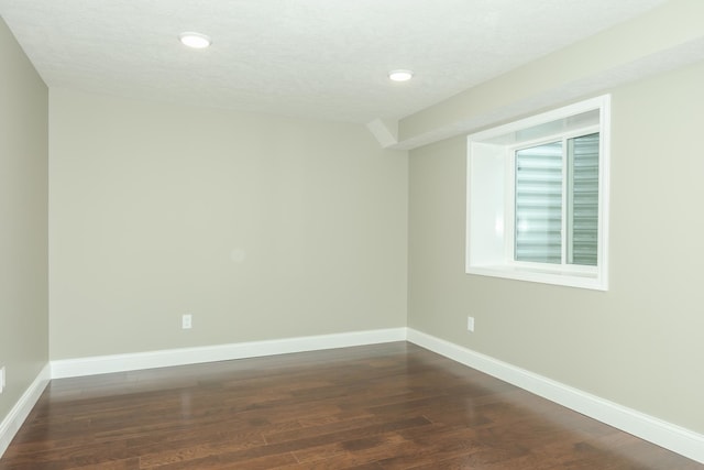 unfurnished room with a textured ceiling and hardwood / wood-style flooring