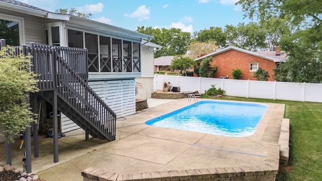 view of pool featuring a sunroom and a patio