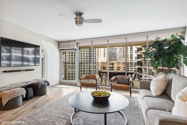 living room featuring ceiling fan and light hardwood / wood-style floors