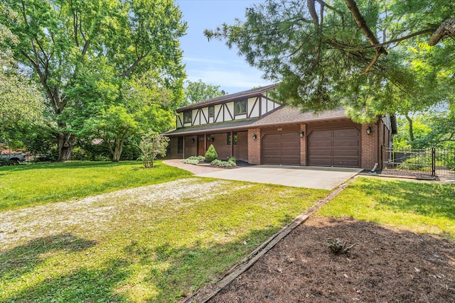 english style home with a garage and a front lawn