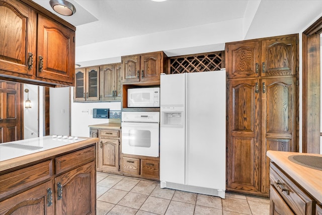 kitchen featuring white appliances and light tile patterned floors