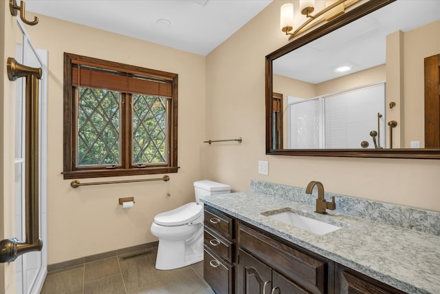 bathroom featuring tile patterned floors, toilet, and vanity