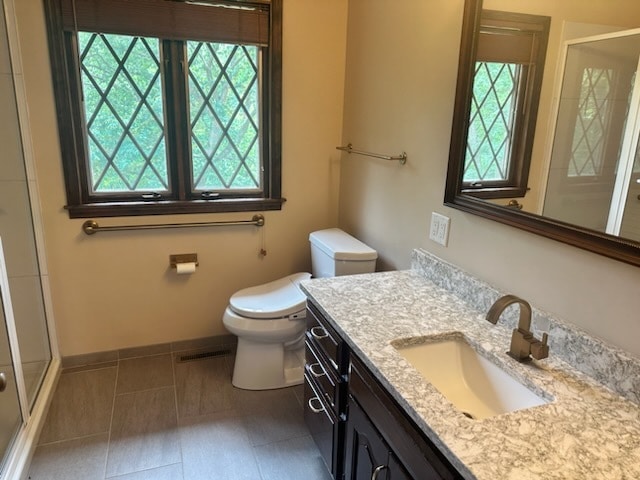 bathroom featuring tile patterned floors, vanity, and toilet