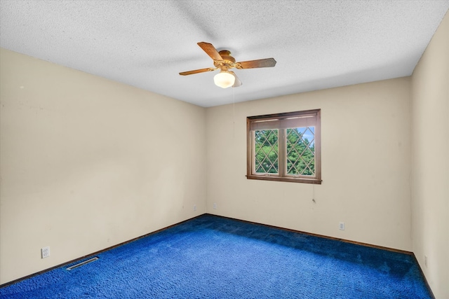 carpeted empty room featuring a textured ceiling and ceiling fan