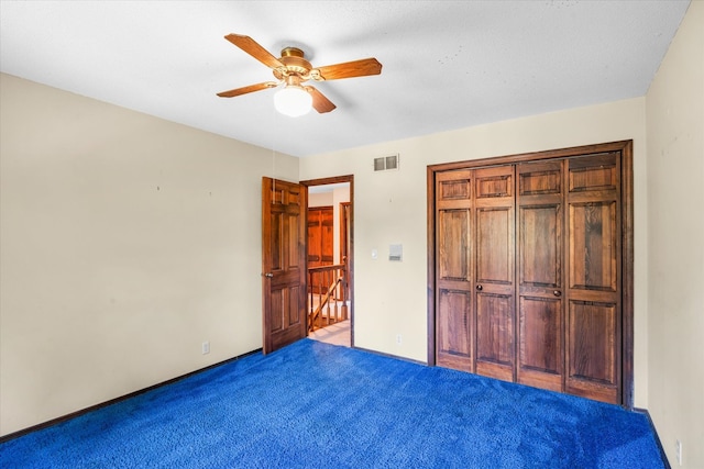 unfurnished bedroom featuring carpet floors, ceiling fan, and a closet