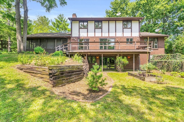 rear view of property featuring a sunroom and a lawn