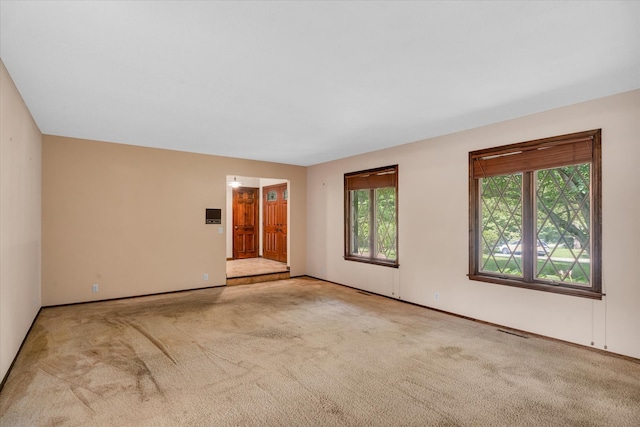 unfurnished room with light colored carpet