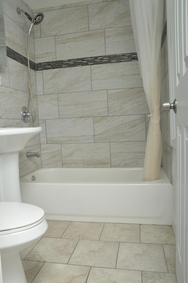 bathroom featuring tile patterned flooring, shower / bathtub combination with curtain, and toilet