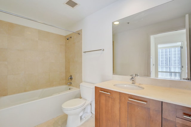 full bathroom featuring tiled shower / bath, tile patterned floors, toilet, and vanity