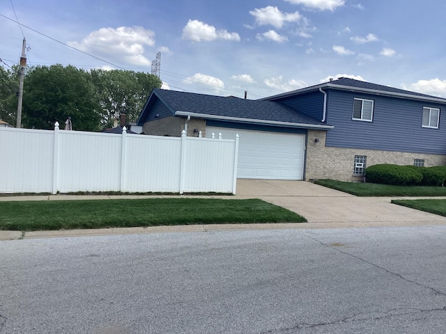 view of home's exterior featuring a garage, concrete driveway, brick siding, and fence