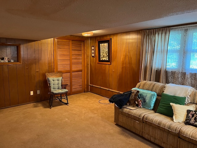 living room with light colored carpet, a textured ceiling, and wooden walls