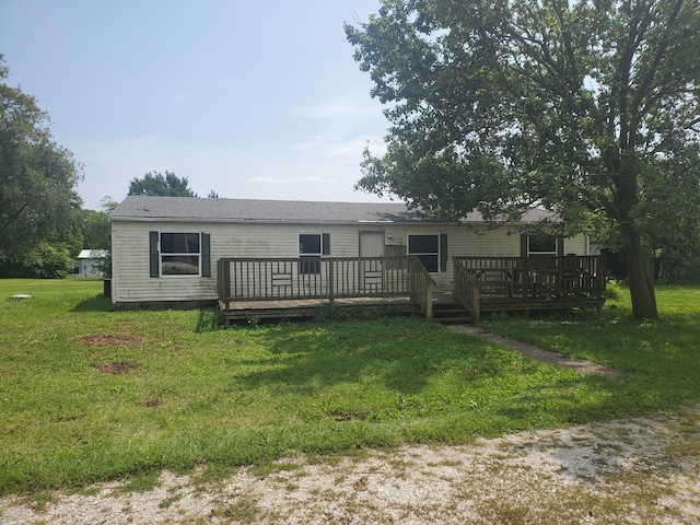 rear view of house with a yard and a wooden deck