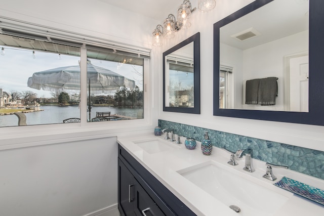 bathroom with a water view, a wealth of natural light, and vanity