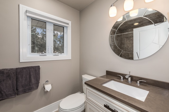 bathroom with toilet and vanity