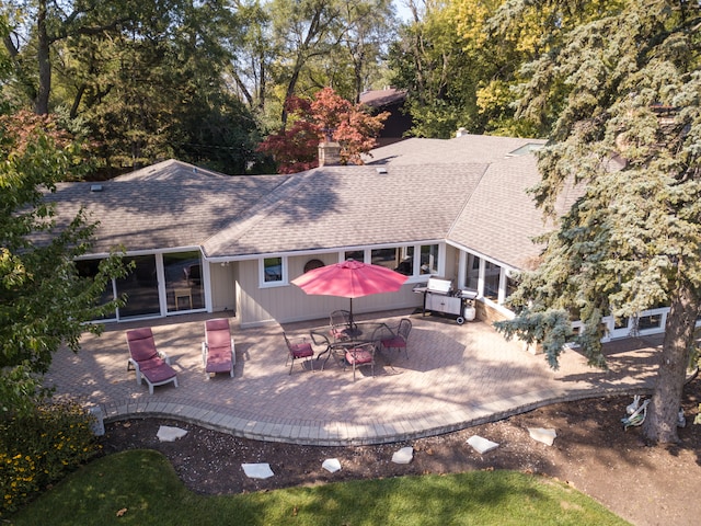 rear view of property featuring a patio area