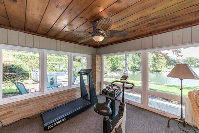 workout room featuring wooden ceiling, a water view, ceiling fan, and carpet floors