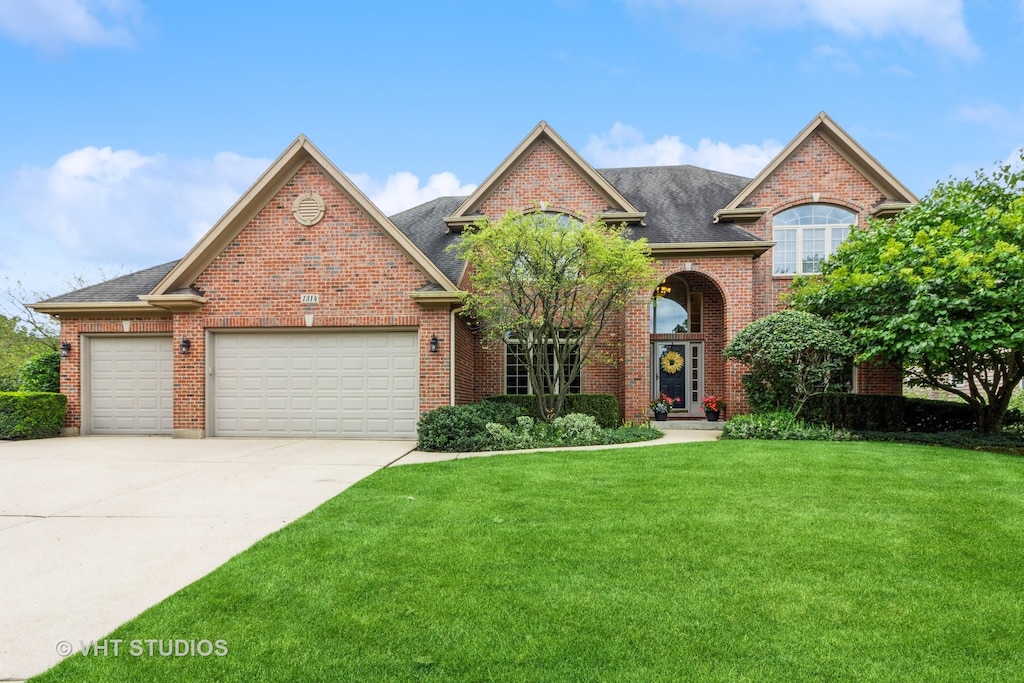 view of front of house featuring a garage and a front lawn