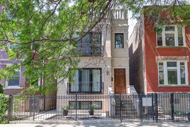 938 N Washtenaw Ave, Chicago, IL 60622 - view of front facade featuring stone siding, a fenced front yard, and a gate