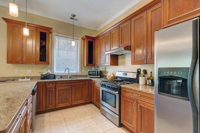 kitchen with appliances with stainless steel finishes, sink, pendant lighting, light tile patterned floors, and light stone countertops