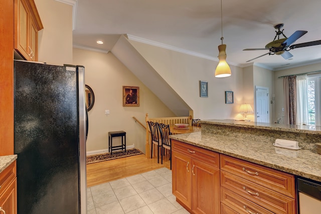 kitchen featuring ceiling fan, pendant lighting, fridge, light stone countertops, and light tile patterned floors