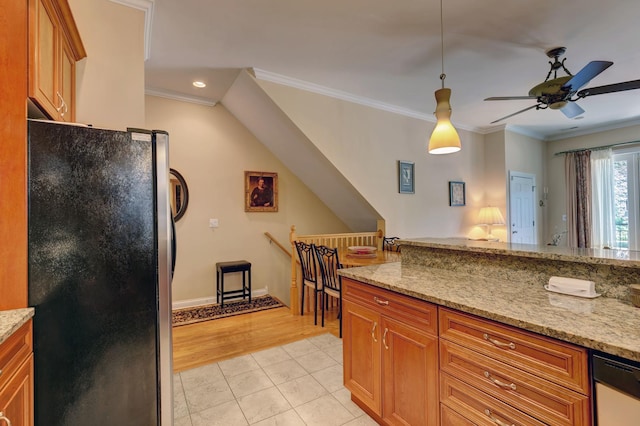 938 N Washtenaw Ave, Chicago, IL 60622 - kitchen with brown cabinetry, freestanding refrigerator, crown molding, and light tile patterned floors