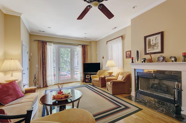938 N Washtenaw Ave, Chicago, IL 60622 - living room featuring visible vents, a ceiling fan, ornamental molding, wood finished floors, and a high end fireplace