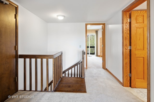 hallway featuring light carpet