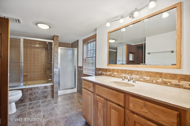 bathroom featuring vanity, tile patterned flooring, tasteful backsplash, and toilet