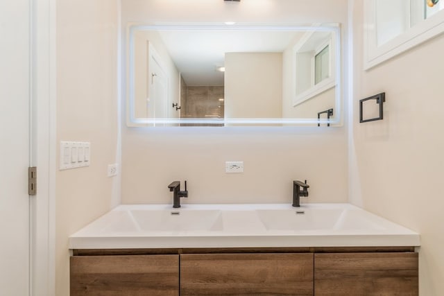 bathroom with walk in shower and vanity