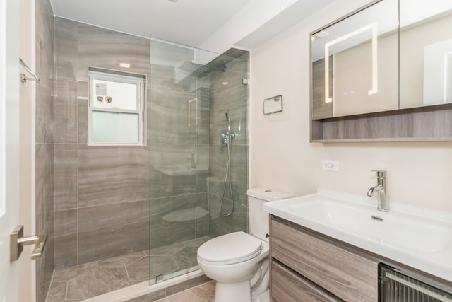 bathroom featuring walk in shower, vanity, and toilet