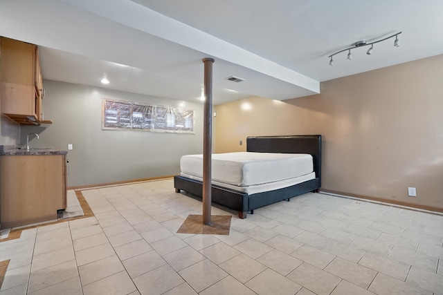 tiled bedroom featuring track lighting and sink