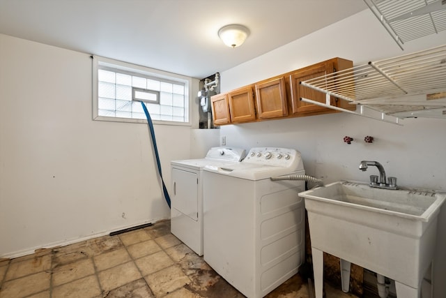 washroom featuring sink, cabinets, washer and dryer, and light tile patterned floors