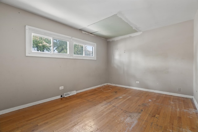 empty room with hardwood / wood-style flooring