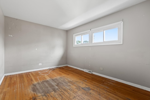 spare room with hardwood / wood-style floors