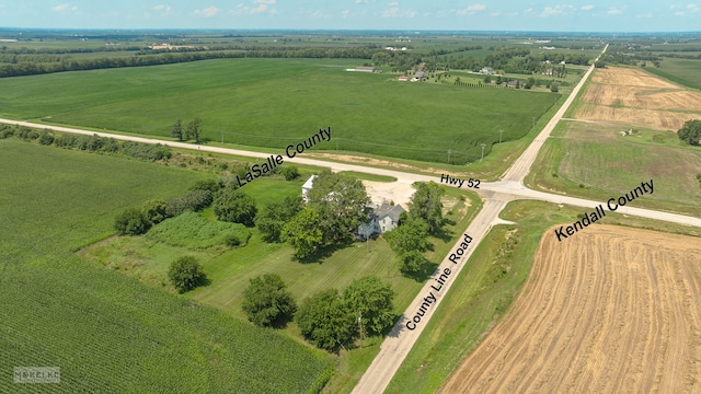 birds eye view of property with a rural view