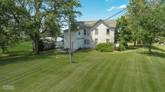 rear view of property featuring a lawn