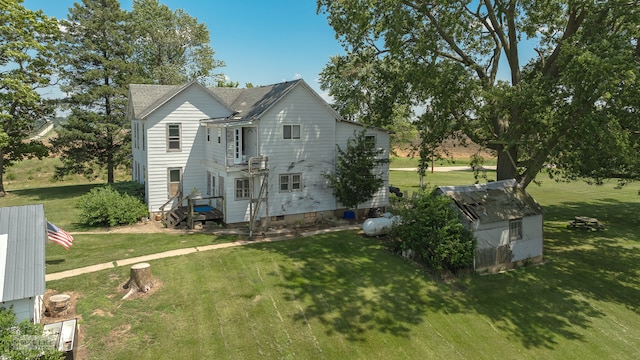 back of property featuring a lawn