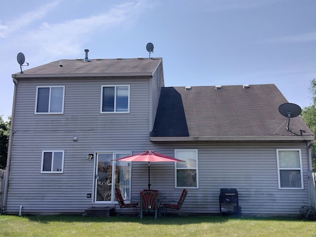 rear view of house with a lawn